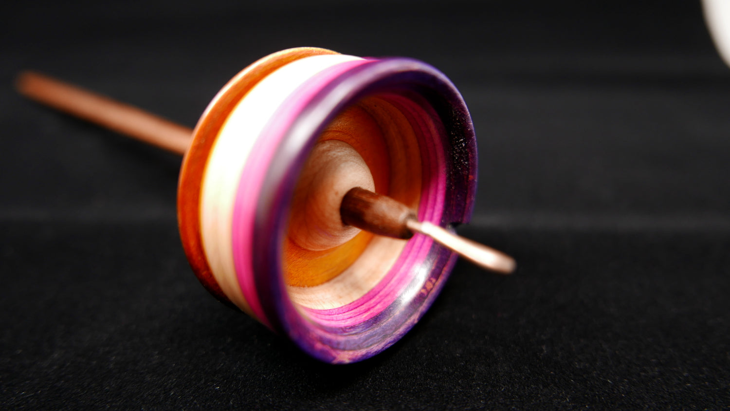 "demitasse" spindle in the colors of the lesbian pride flag